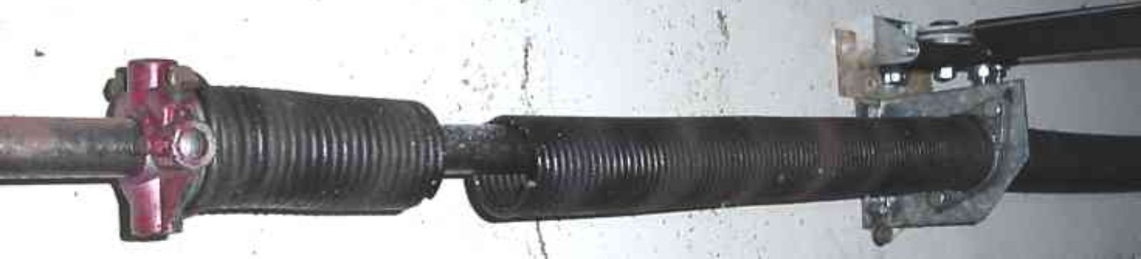 Close-up of damaged garage door spring before replacement in Anoka, MN