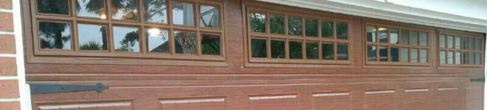 Close-up of Clopay wood panel design and windows on newly installed garage door in Blaine, MN