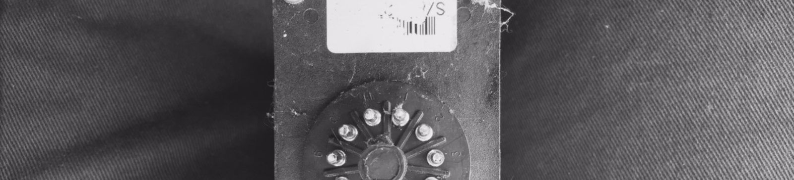 Misaligned garage door safety sensors near the track before professional repair in Champlin, MN