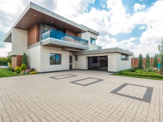 Contemporary home with modern garage door in Champlin, MN Stylish modern house featuring a sleek garage door and landscaped driveway in Champlin, MN