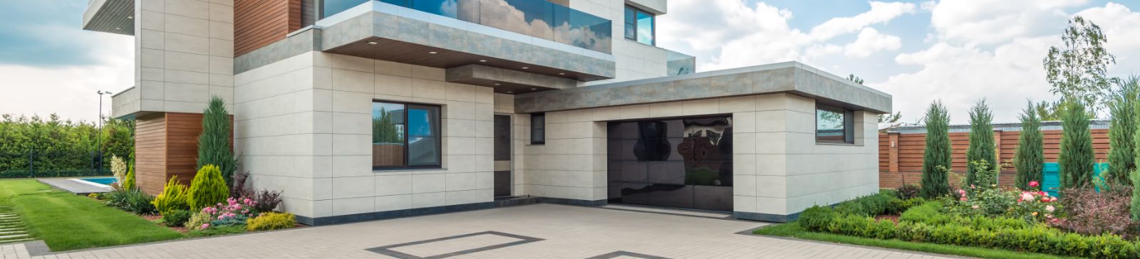 Stylish modern house featuring a sleek garage door and landscaped driveway in Champlin, MN