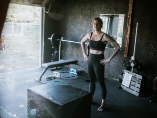 Private Garage Gym with Modern Organization in Champlin MN Woman standing in a well-organized private garage gym with custom storage in Champlin, MN