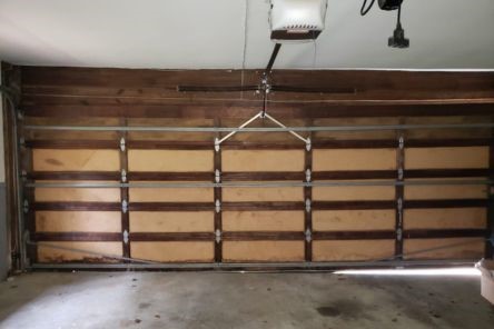 Close-up of garage door panels and track system before professional installation in Ramsey, MN.