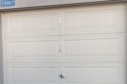 Close-up of garage door lock and handle on newly installed overhead garage door in Champlin, MN.